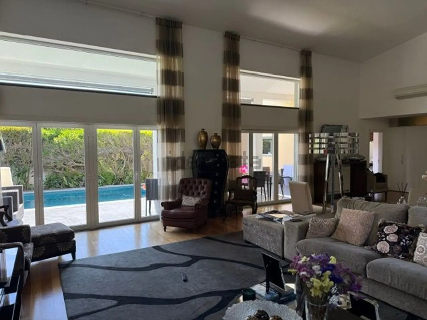 The double-height living room, with glass doors to the pool