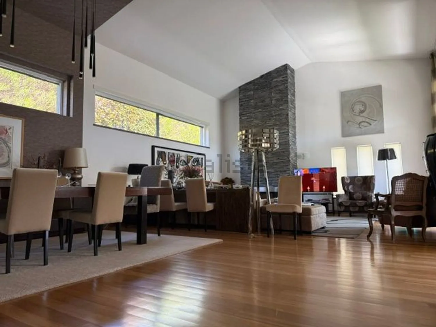 Dining area and living room under the high ceiling