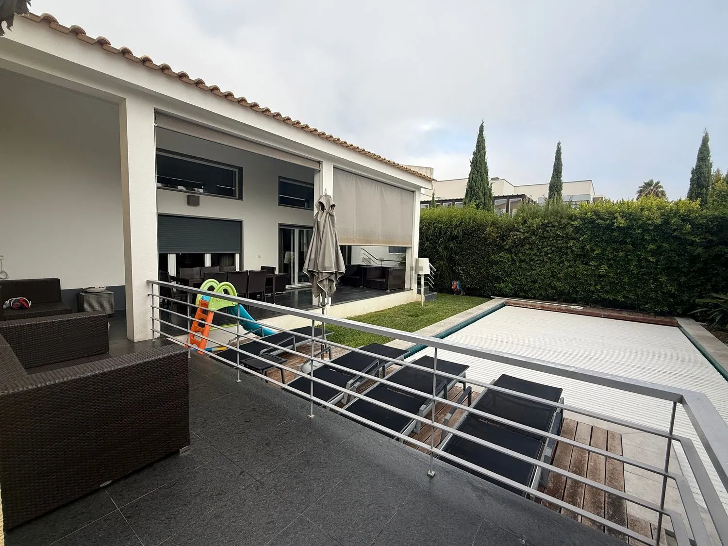 The covered terrace beside the pool
